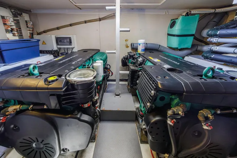 Slide: The Image of Engine room of a 2015 Prestige 500FB yacht, featuring dual engines and organized equipment. - 55