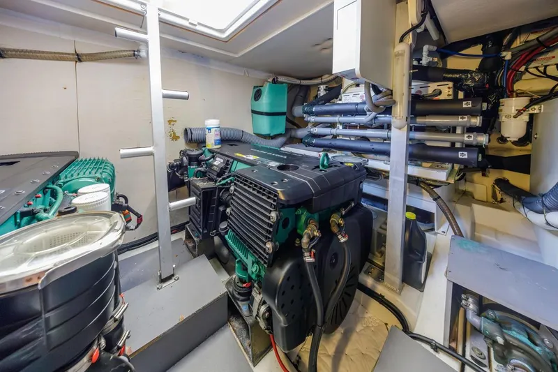 Slide: The Image of Engine room of a 2015 Prestige 500FB yacht, showcasing mechanical components and systems. - 56
