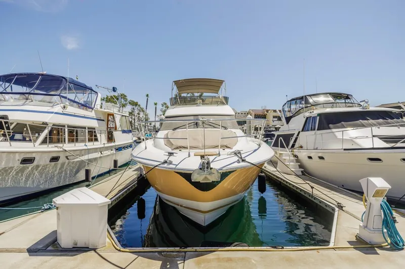 Slide: The Image of 2015 Prestige 500FB yacht docked at marina, surrounded by other boats under clear blue sky. - 8