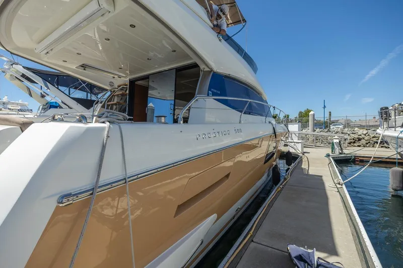 Slide: The Image of 2015 Prestige 500FB yacht docked at marina under clear blue sky. - 9