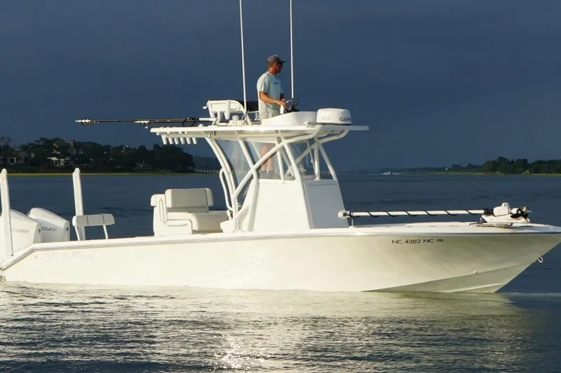 Slide: The Image of 2022 SeaHunter 28 Floridian boat on calm water with a person navigating. - 10