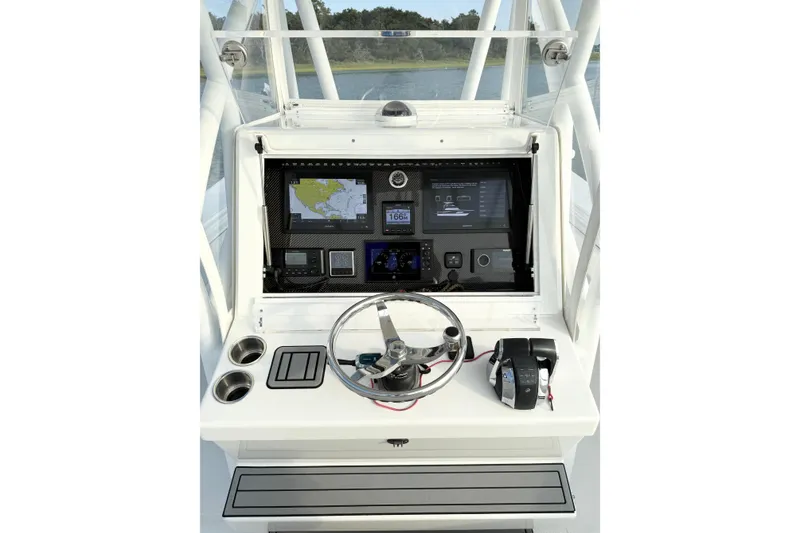 Slide: The Image of 2022 SeaHunter 28 Floridian boat console with navigation screens and steering wheel. - 14