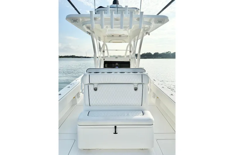 Slide: The Image of 2022 SeaHunter 28 Floridian boat interior with cushioned seating and rod holders. - 15