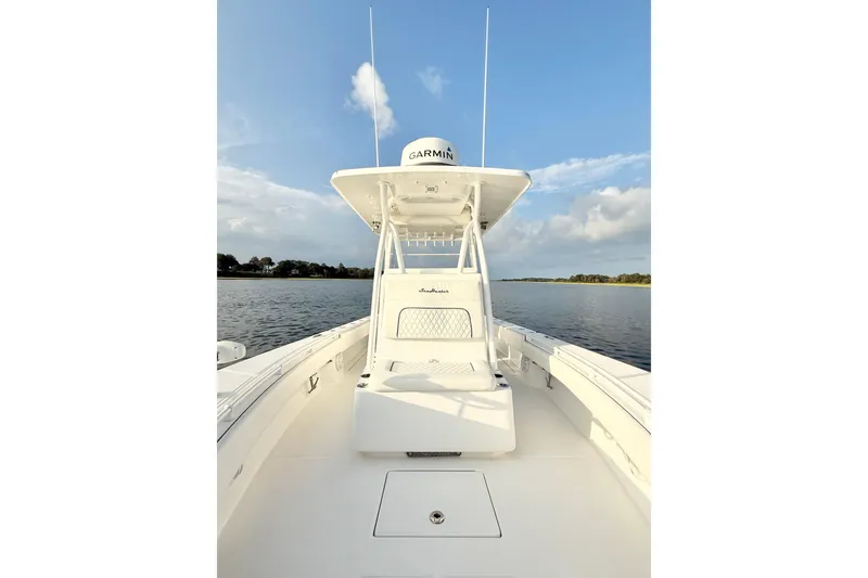 Slide: The Image of 2022 SeaHunter 28 Floridian boat on calm water under blue sky. - 16