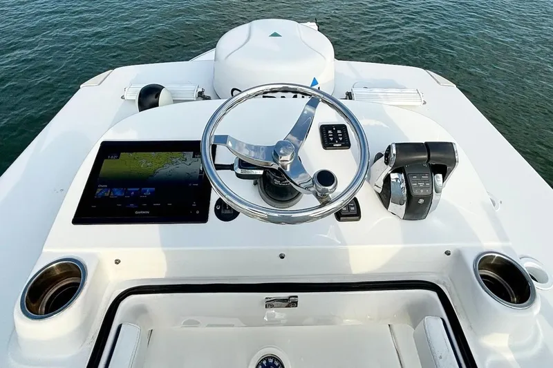 Slide: The Image of 2022 SeaHunter 28 Floridian boat helm with steering wheel and navigation system. - 18