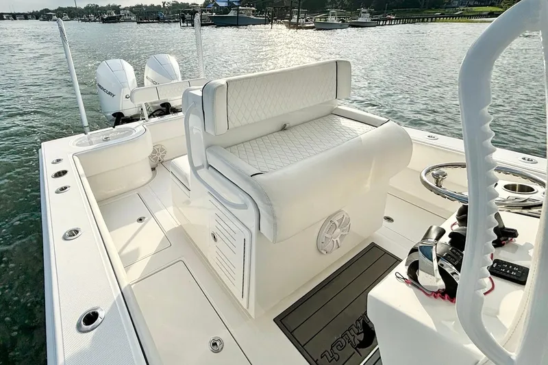 Slide: The Image of 2022 SeaHunter 28 Floridian boat interior with dual Mercury engines, white seating, and steering console. - 19