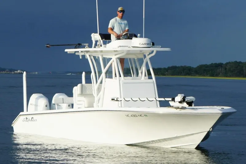 Slide: The Image of 2022 SeaHunter 28 Floridian boat on water, featuring dual engines and a center console. - 2