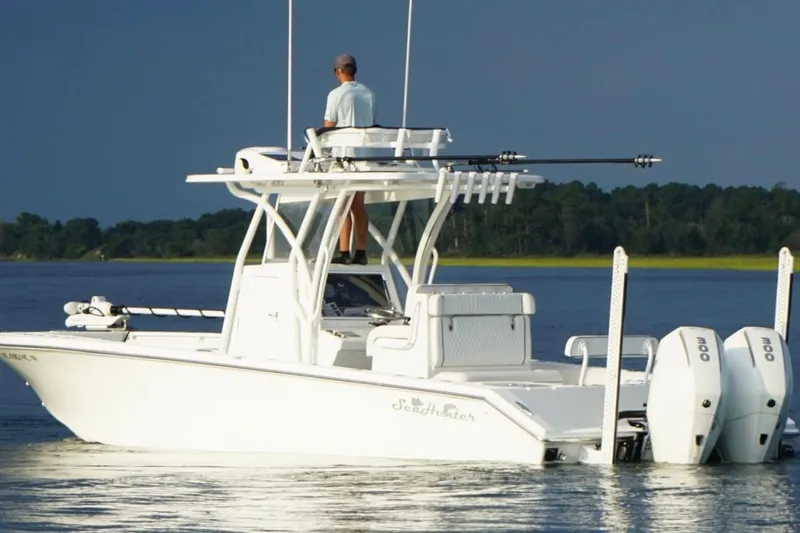 Slide: The Image of 2022 SeaHunter 28 Floridian boat on calm water with dual engines and fishing gear. - 3