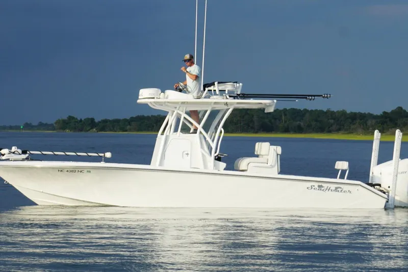 Slide: The Image of 2022 SeaHunter 28 Floridian boat on calm water, with person on deck. - 5