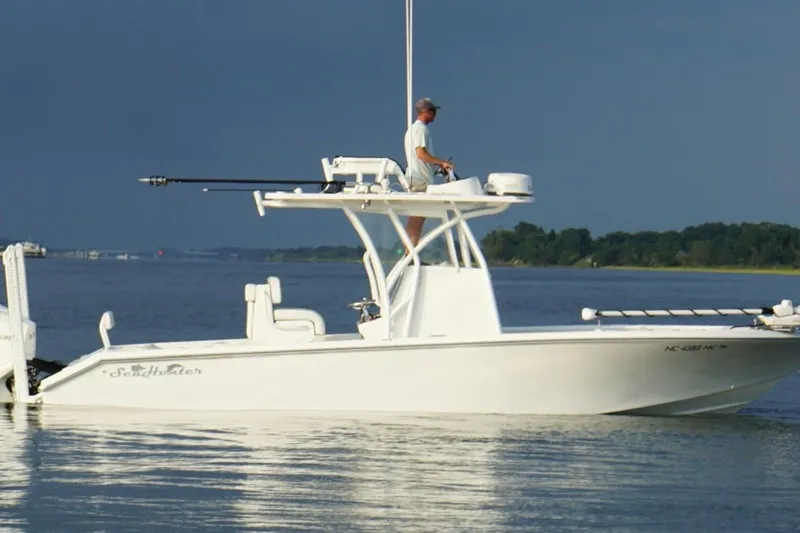 Slide: The Image of 2022 SeaHunter 28 Floridian boat on calm water with a person navigating. - 6