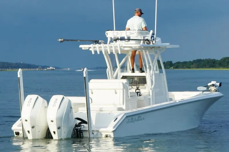 Slide: The Image of 2022 SeaHunter 28 Floridian boat on water, featuring dual engines and a person navigating. - 7