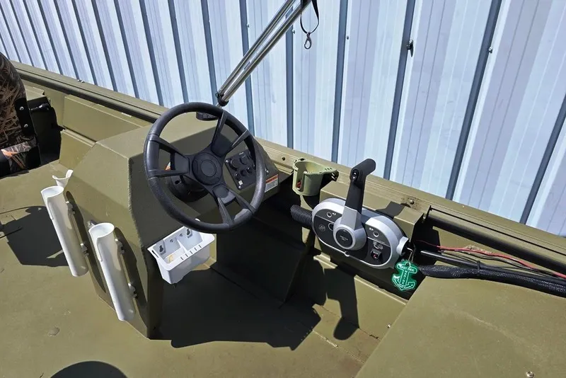 Slide: The Image of 2022 Lowe Roughneck RX1860 Rambler boat interior with steering wheel and controls. - 2