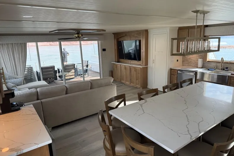 Slide: The Image of Luxurious 2025 Sumerset Excellence houseboat interior with modern kitchen, spacious living area, and lake view. - 25