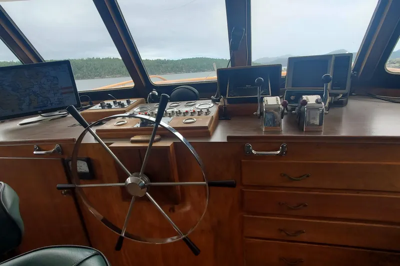 Slide: The Image of 1965 Tacoma Boat Works Bill Garden Motor Yacht helm with navigation equipment and wooden dashboard. - 10