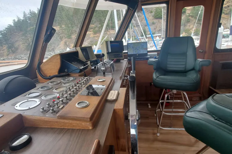 Slide: The Image of Interior of 1965 Tacoma Boat Works Bill Garden Motor Yacht, featuring vintage controls and seating. - 11