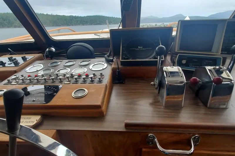 Slide: The Image of 1965 Tacoma Boat Works Bill Garden Motor Yacht dashboard with vintage controls and navigation instruments. - 12