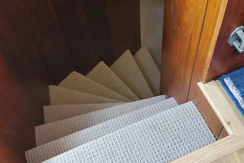 Slide: The Image of Carpeted stairs inside a 1965 Tacoma Boat Works Bill Garden Motor Yacht. - 15