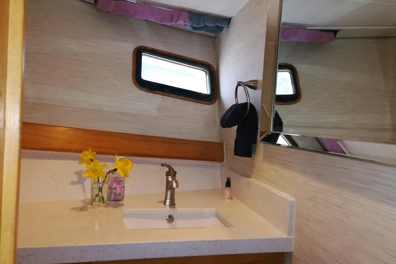 Slide: The Image of Bathroom interior of 1965 Tacoma Boat Works Bill Garden Motor Yacht, featuring sink and window. - 19