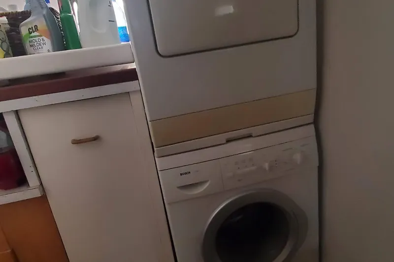 Slide: The Image of Stacked washer and dryer in a compact laundry area on a 1965 Tacoma Boat Works yacht. - 21