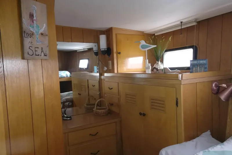 Slide: The Image of Interior of 1965 Tacoma Boat Works Bill Garden Motor Yacht with wooden paneling and nautical decor. - 23