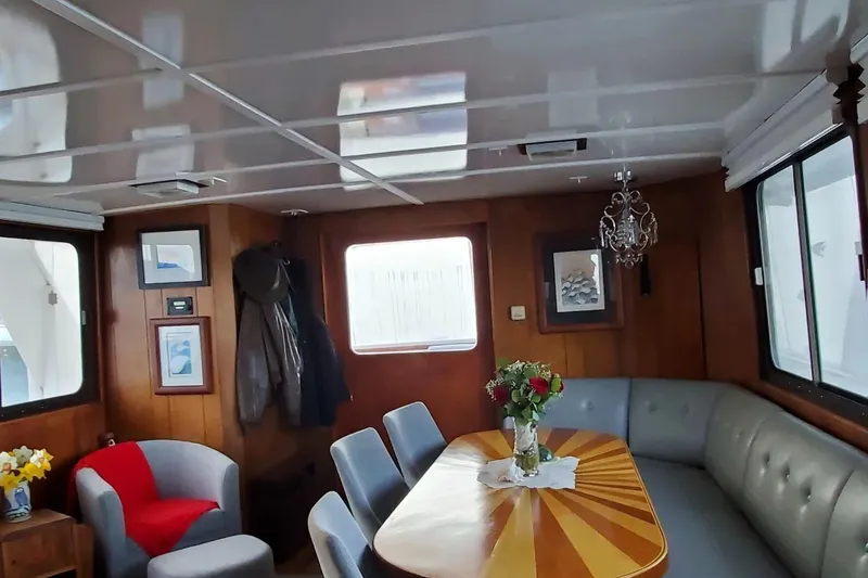 Slide: The Image of Interior of 1965 Tacoma Boat Works Bill Garden Motor Yacht, featuring elegant dining area. - 4