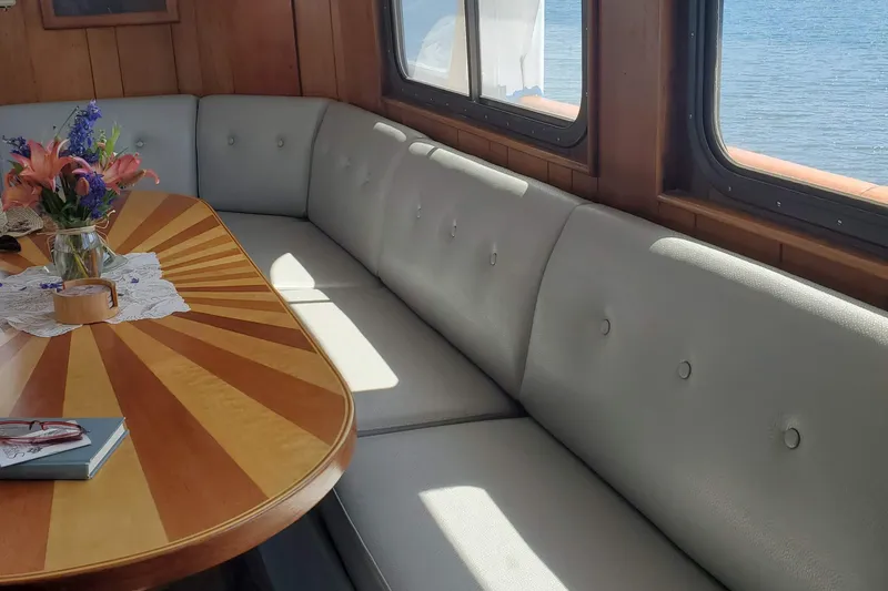Slide: The Image of Interior of 1965 Tacoma Boat Works Bill Garden Motor Yacht with elegant seating and floral centerpiece. - 5