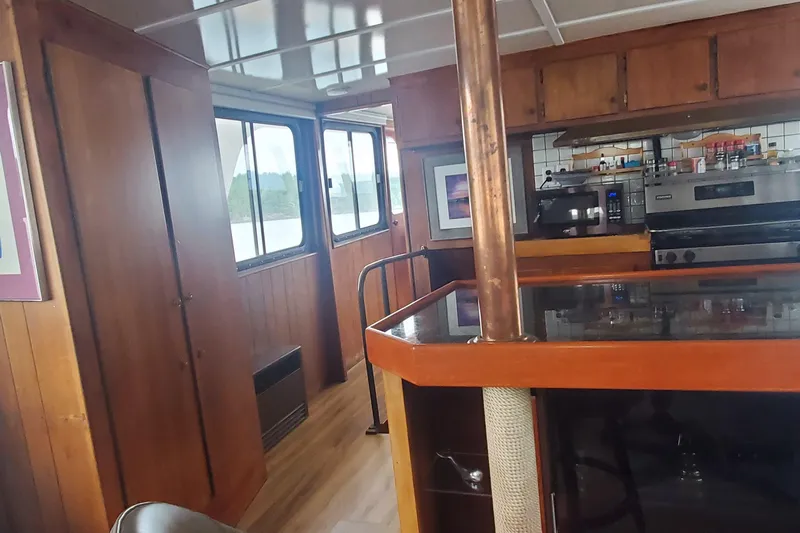 Slide: The Image of Interior of 1965 Tacoma Boat Works Bill Garden Motor Yacht with wood paneling and kitchen area. - 9