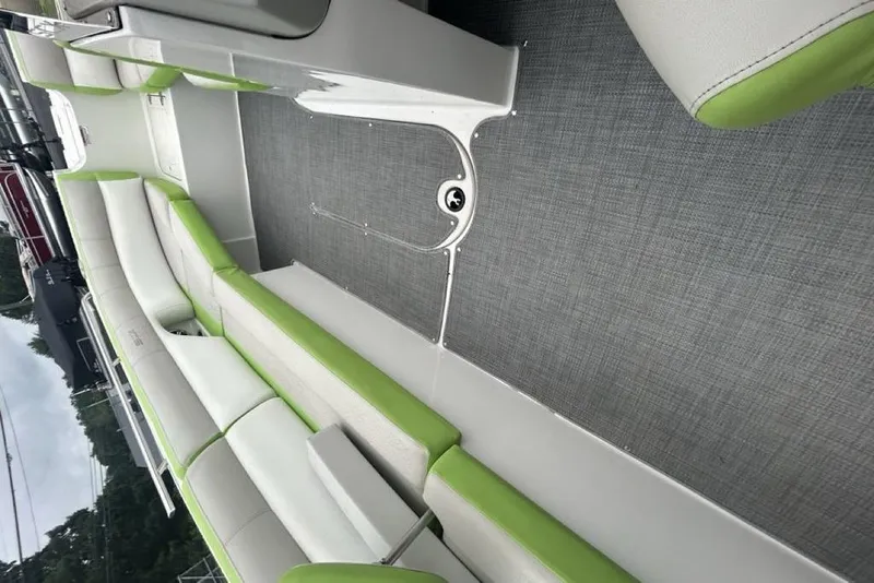 Slide: The Image of 2018 Starcraft 211 I/O SCX boat interior with green and white seating. - 13