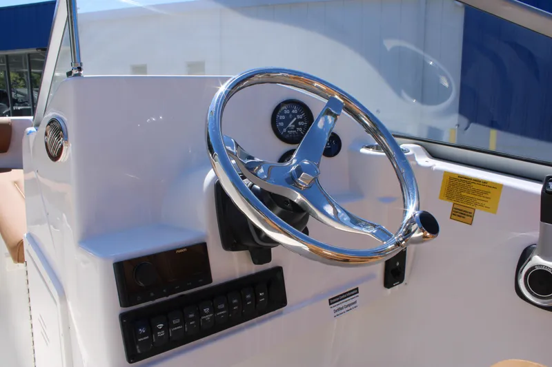 Slide: The Image of Steering console of 2026 Key West 203 DFS boat with chrome wheel and controls. - 11
