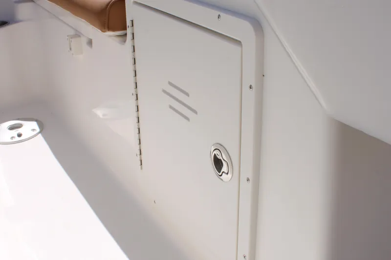 Slide: The Image of 2026 Key West 203 DFS boat interior storage compartment with latch. - 19