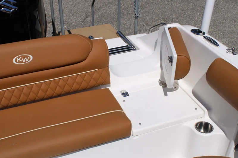 Slide: The Image of 2026 Key West 203 DFS boat interior with brown cushioned seating and storage compartment. - 21