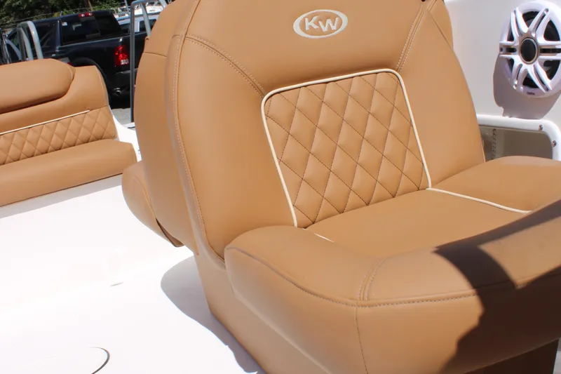 Slide: The Image of Luxurious tan seating on 2026 Key West 203 DFS boat, featuring diamond stitching and speaker detail. - 24