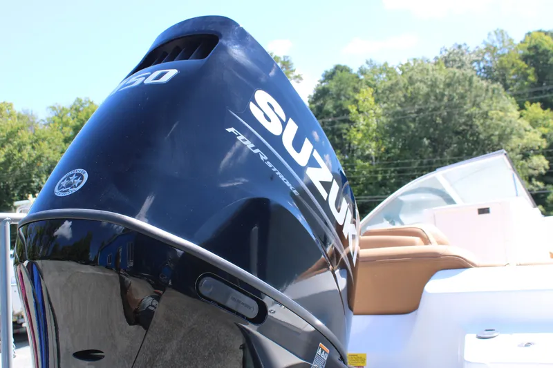 Slide: The Image of 2026 Key West 203 DFS boat with Suzuki outboard motor in a sunny outdoor setting. - 27
