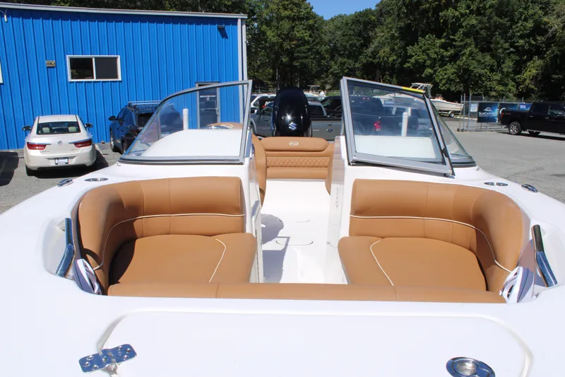 Slide: The Image of 2026 Key West 203 DFS boat with tan seating, parked outdoors near blue building. - 6