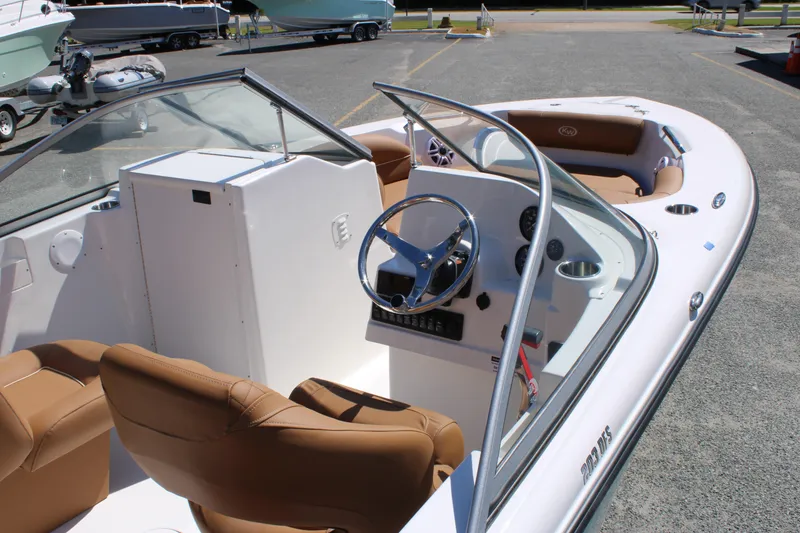 Slide: The Image of 2026 Key West 203 DFS boat interior with steering wheel and seating. - 8