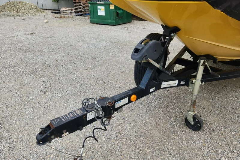 Slide: The Image of 2006 MasterCraft MariStar 200 boat on trailer, surrounded by lush greenery. - 6