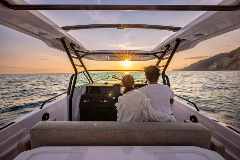 Slide: The Image of Couple enjoying sunset on 2025 Axopar 37 Sun Top BRABUS Trim boat. - 7