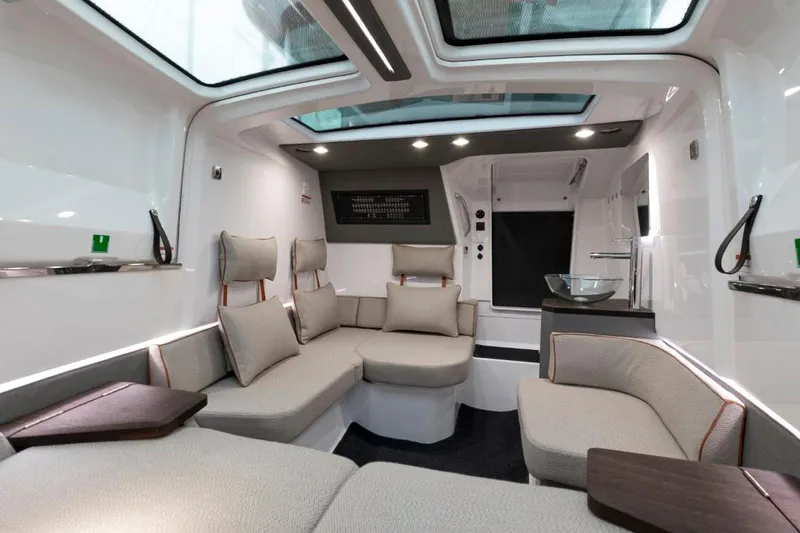 Slide: The Image of Luxurious interior of 2025 Axopar 37 Sun Top BRABUS Trim with modern seating and skylights. - 8