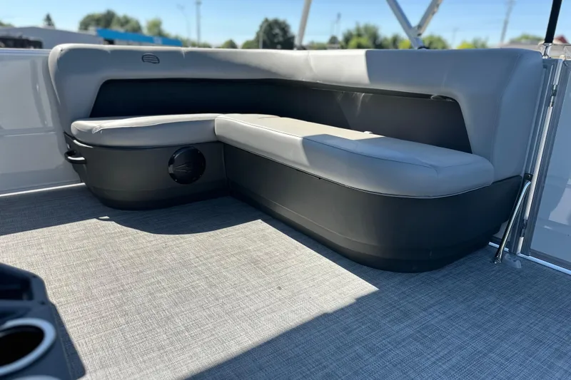 Slide: The Image of 2026 Sun Tracker Party Barge 16 DLX interior seating with gray upholstery and carpeted floor. - 12
