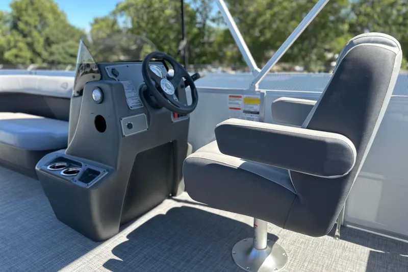 Slide: The Image of 2026 Sun Tracker Party Barge 16 DLX interior with steering console and seating. - 13