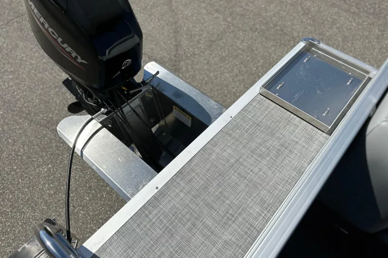 Slide: The Image of 2026 Sun Tracker Party Barge 16 DLX with Mercury outboard motor, rear deck view. - 16