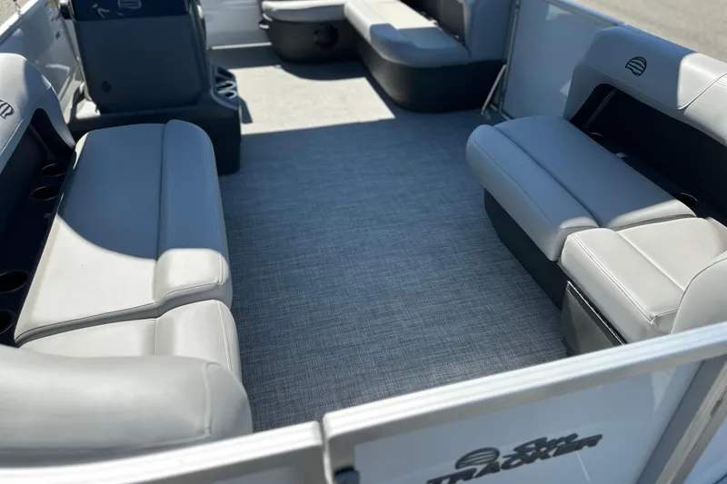 Slide: The Image of 2026 Sun Tracker Party Barge 16 DLX interior with gray seating and spacious layout. - 4