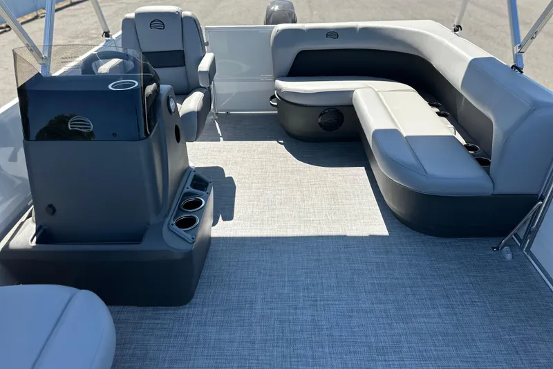 Slide: The Image of 2026 Sun Tracker Party Barge 16 DLX interior with gray seating and helm station. - 6