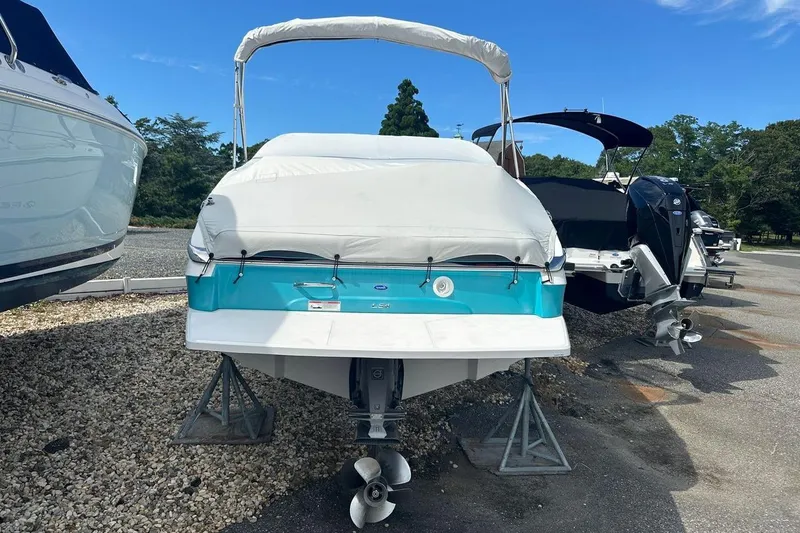 Slide: The Image of 2020 Regal LS4 boat with cover, parked on stands in a marina. - 15