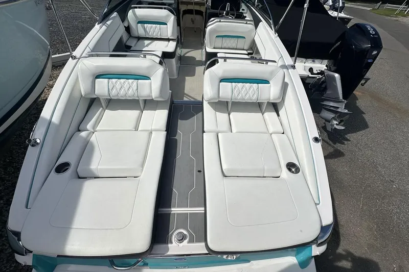 Slide: The Image of 2020 Regal LS4 boat interior with white seating and teal accents. - 5