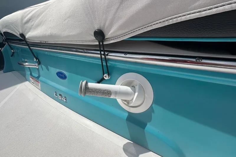 Slide: The Image of 2020 Regal LS4 boat with turquoise exterior and covered seating area. - 7