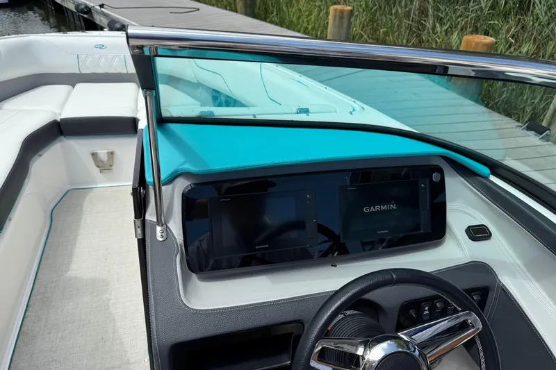 Slide: The Image of 2020 Regal LS4 boat dashboard with Garmin navigation system, sleek design, and comfortable seating. - 8