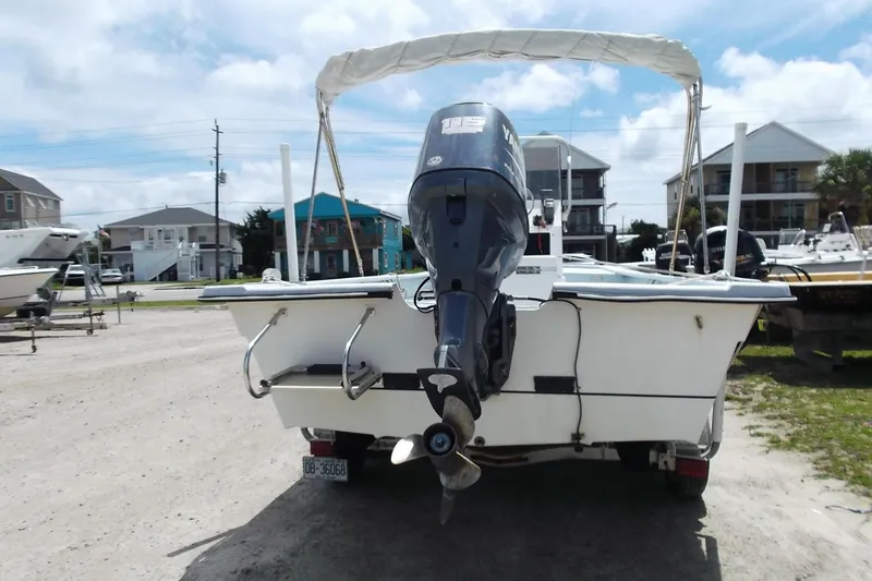 Slide: The Image of 2008 Hancock 22 boat with outboard motor, parked in a coastal residential area. - 3