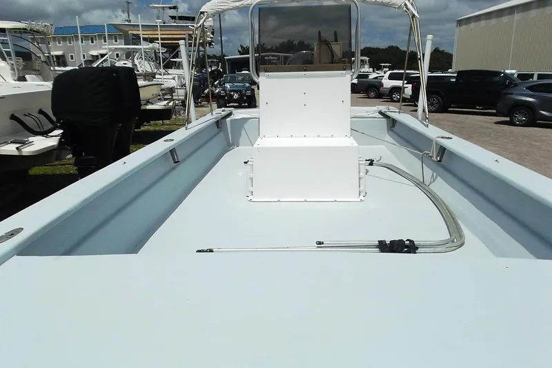 Slide: The Image of 2008 Hancock 22 boat interior with console, parked among other boats and vehicles. - 6