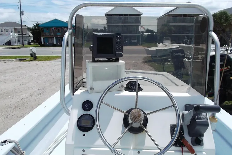 Slide: The Image of 2008 Hancock 22 boat dashboard with steering wheel and navigation equipment. - 9